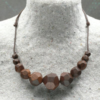Natural handmade 15 sided Polygon wooden beaded necklace with 11 beads ranging from small to big to small again. Threaded on a waxed cotton sliding cord-made in Melbourne-Australia