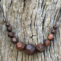 Natural handmade 15 sided Polygon wooden beaded necklace with 11 beads ranging from small to big to small again. Threaded on a waxed cotton sliding cord-made in Melbourne-Australia