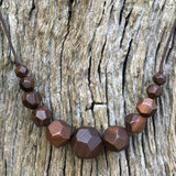 Natural handmade 15 sided Polygon wooden beaded necklace with 11 beads ranging from small to big to small again. Threaded on a waxed cotton sliding cord-made in Melbourne-Australia