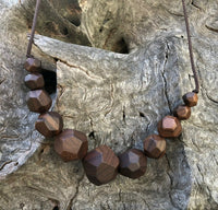 Natural handmade 15 sided Polygon wooden beaded necklace with 11 beads ranging from small to big to small again. Threaded on a waxed cotton sliding cord-made in Melbourne-Australia